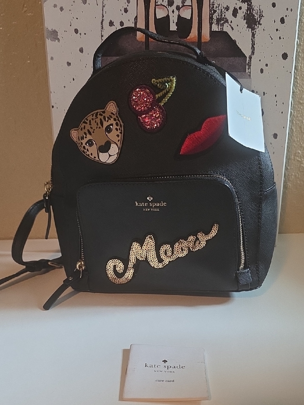 kate spade RUN WILD black mini backpack with playful patch details